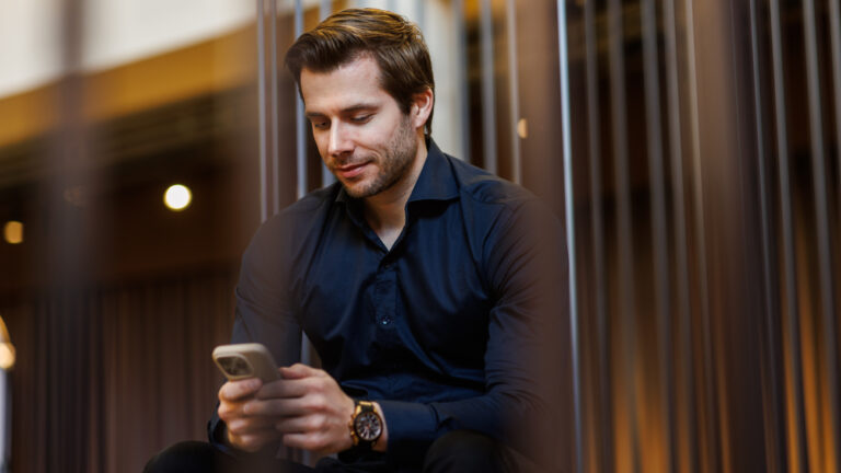 man-looking-at-his-phone